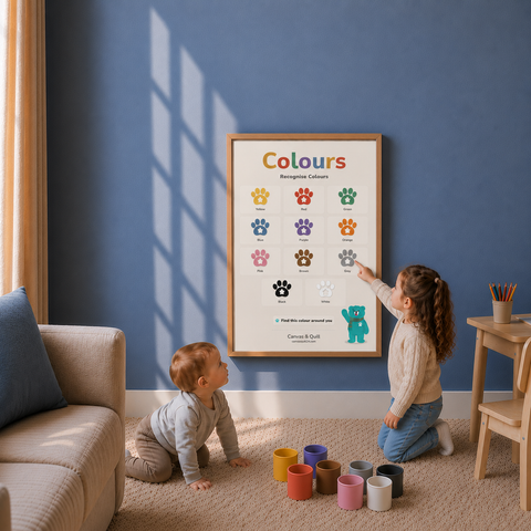 Children recognising colours together using the Landing Ready® Colours Wall Chart. A framed colour learning poster hangs on a blue wall in a child's playroom, with a baby crawling nearby and a child pointing at the colorful colour cards. Paint cups on the floor and a sofa are visible.