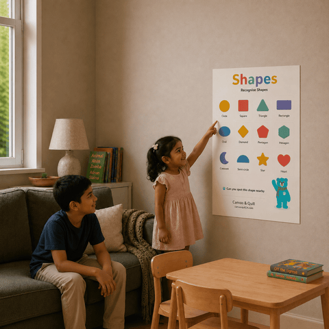 Children exploring the Landing Ready® Shapes Wall Chart together through shared shape recognition and everyday learning. A child's educational poster titled 'Shapes' hangs on a beige wall in a cozy room. A young girl in a pink dress points at the colorful shapes on the poster, whilst her brother sits on a gray sofa watching her proudly