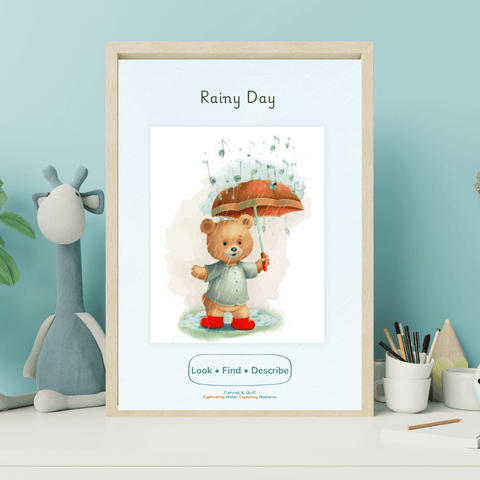 A framed children's art print titled 'Rainy Day' featuring a teddy bear holding an umbrella, displayed on a white shelf next to a blue giraffe toy and desk accessories.